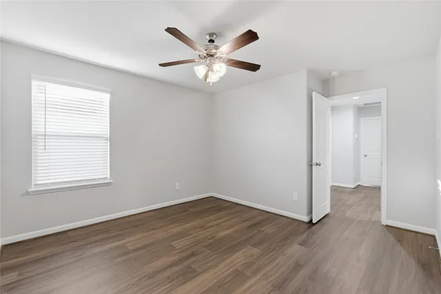 a view of an empty room and wooden floor