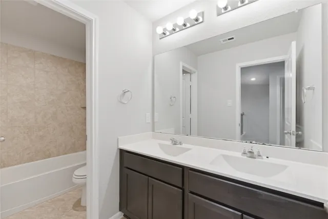 a bathroom with a toilet a sink and bathtub