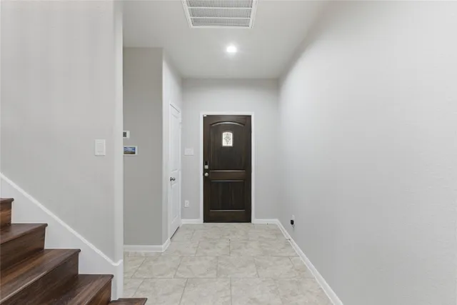 a view of a kitchen with a sink and a refrigerator