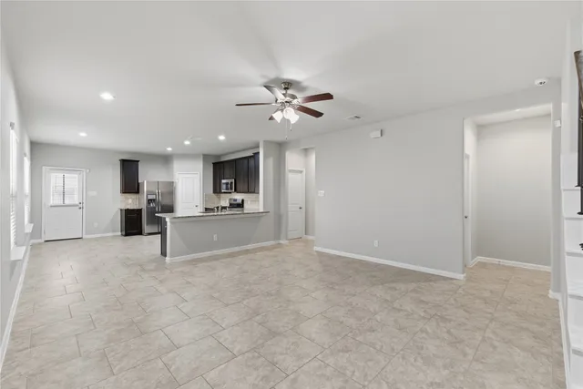 a view of a kitchen with furniture and a ceiling fan