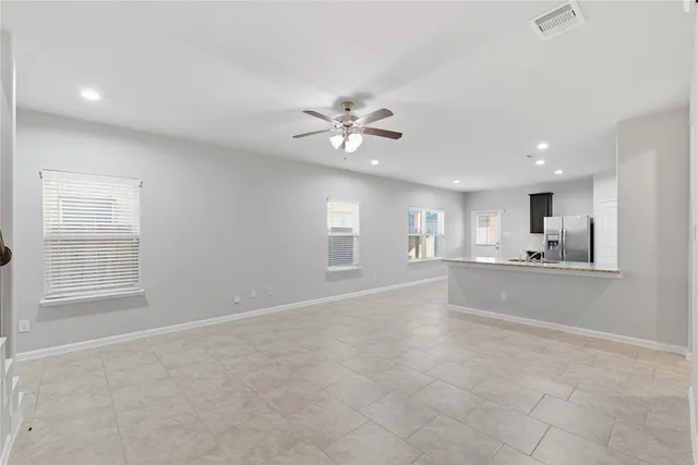 a kitchen with stainless steel appliances granite countertop a stove top oven a sink and a refrigerator