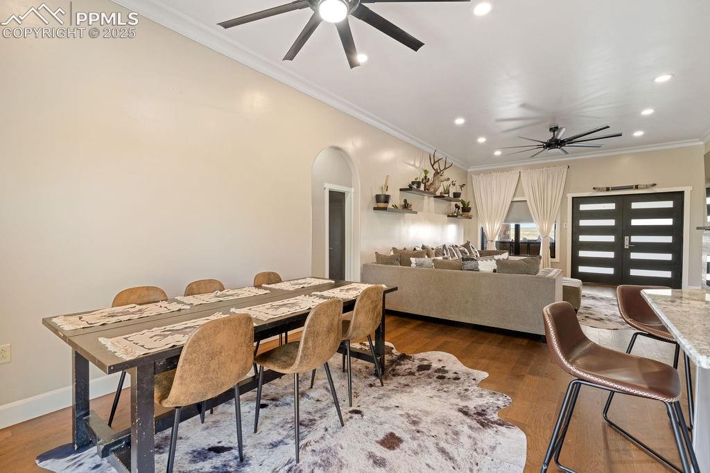 8450 Edison Road Yoder, CO 80864 - Photo 15 of 50 a kitchen with stainless steel appliances kitchen island granite countertop a dining table chairs and a refrigerator