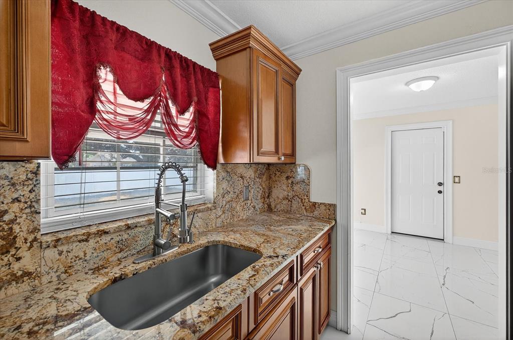 2015 Balfour Circle Tampa, FL 33619 - Photo 21 of 42 a kitchen with a sink cabinets and a wooden floor