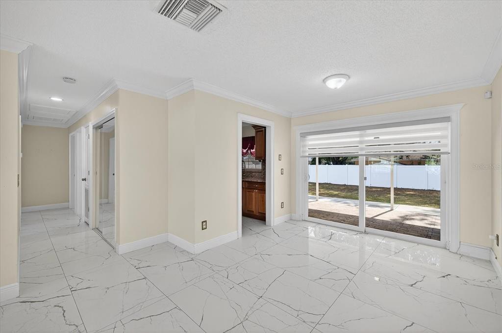 2015 Balfour Circle Tampa, FL 33619 - Photo 22 of 42 an empty room with fireplace and chandelier