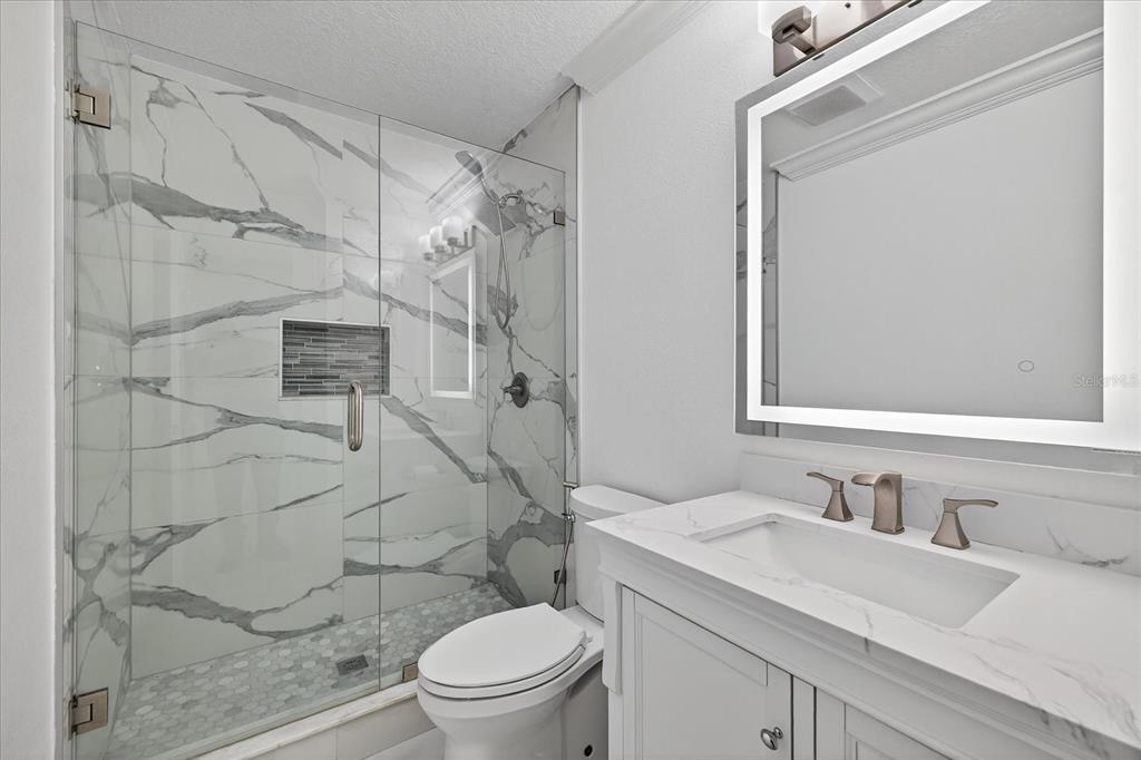 2015 Balfour Circle Tampa, FL 33619 - Photo 24 of 42 a bathroom with a granite countertop sink toilet and shower