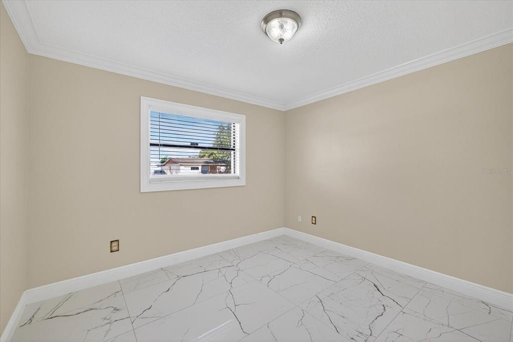 2015 Balfour Circle Tampa, FL 33619 - Photo 28 of 42 an empty room with windows
