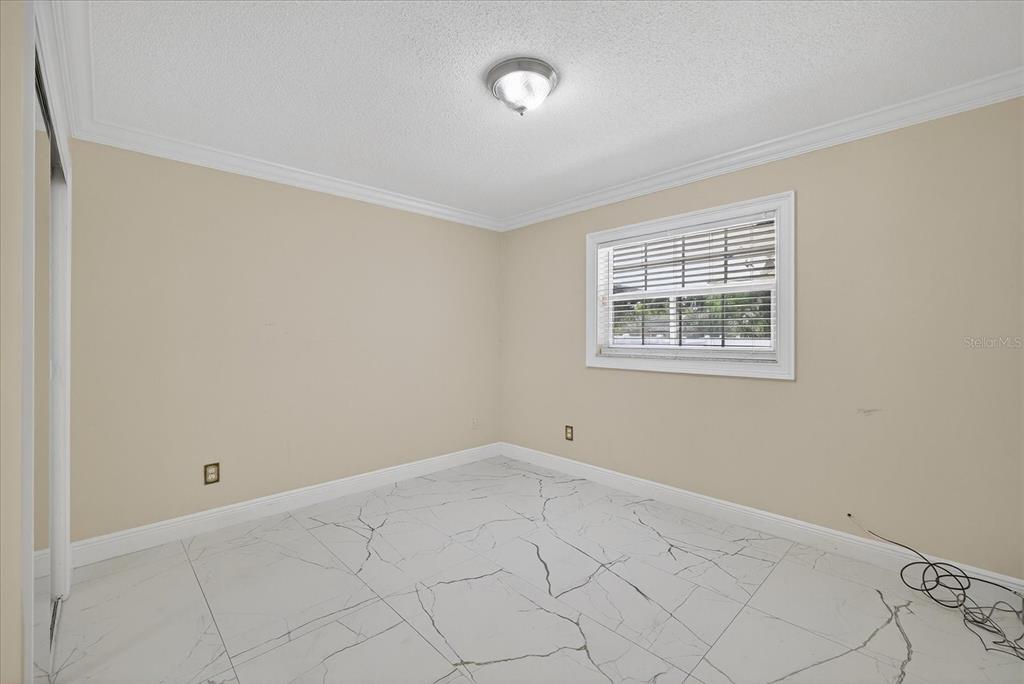 2015 Balfour Circle Tampa, FL 33619 - Photo 30 of 42 an empty room with windows