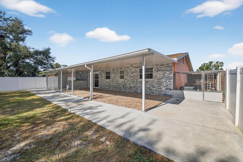 2015 Balfour Circle Tampa, FL 33619 - Photo 38 of 42 a view of a house with a backyard and porch