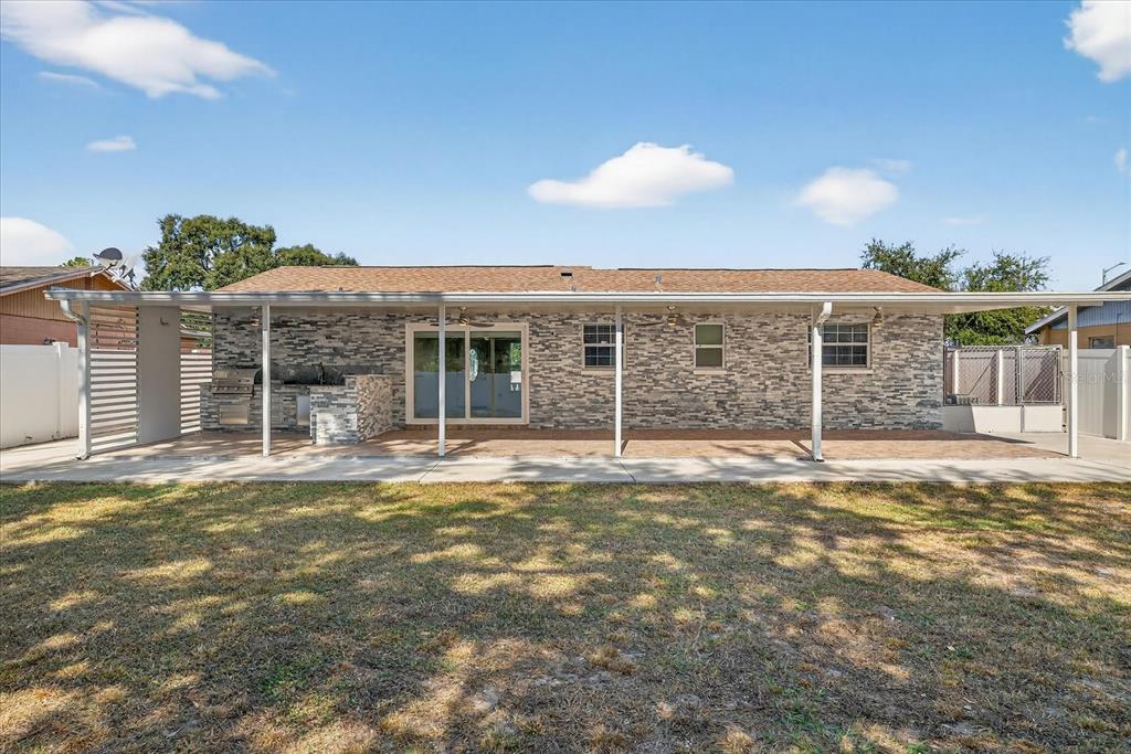 2015 Balfour Circle Tampa, FL 33619 - Photo 40 of 42 a view of a house with a backyard and a large window