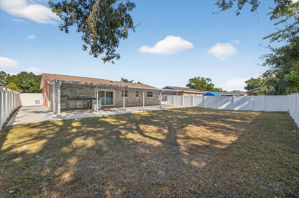 2015 Balfour Circle Tampa, FL 33619 - Photo 41 of 42 a view of a house with a backyard and a tree