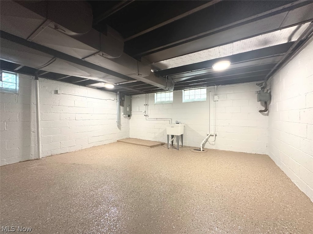 4227 Eastway Road South Euclid, OH 44121 - Photo 15 of 18 Basement with sink, a wealth of natural light, and electric panel