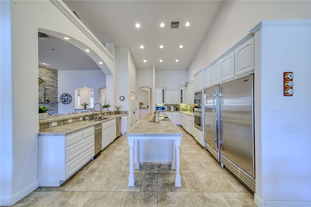 10023 Dike Road Mohave Valley, AZ 86440 - Photo 17 of 100 a large kitchen with stainless steel appliances kitchen island granite countertop a refrigerator and a sink