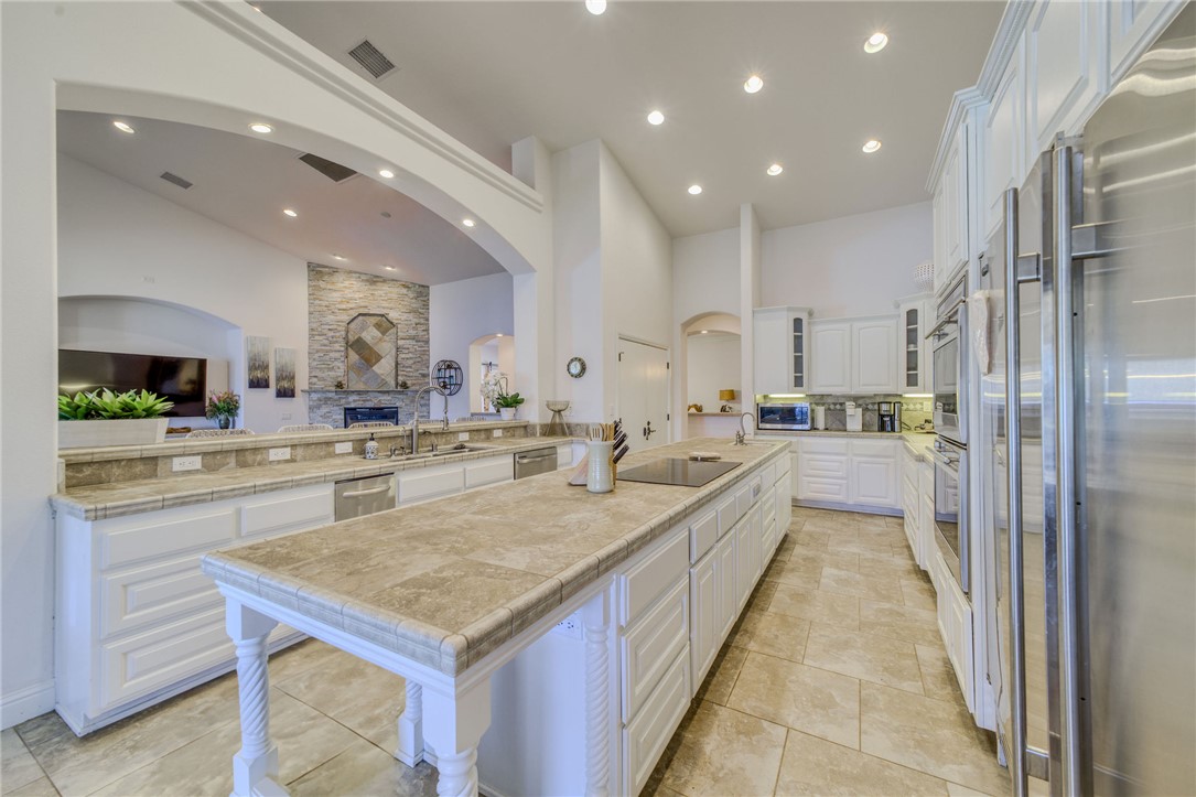 10023 Dike Road Mohave Valley, AZ 86440 - Photo 18 of 100 a large kitchen with kitchen island a large counter top stainless steel appliances and cabinets