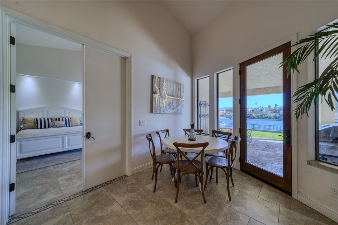 10023 Dike Road Mohave Valley, AZ 86440 - Photo 21 of 100 a view of a dining room with furniture and a floor to ceiling window