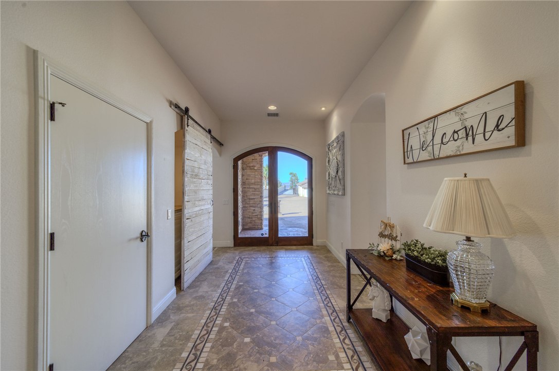 10023 Dike Road Mohave Valley, AZ 86440 - Photo 3 of 100 a view of a hallway with entryway wooden floor and front door