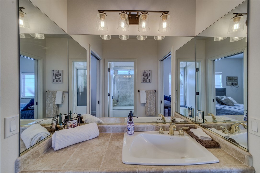 10023 Dike Road Mohave Valley, AZ 86440 - Photo 42 of 100 a bathroom with a double vanity sink a mirror and a shower