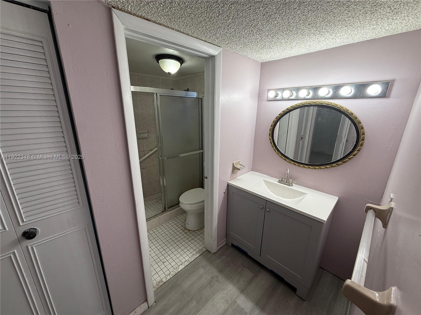 7355 West 4th Avenue, Unit 214 Hialeah, FL 33014 - Photo 12 of 15 a bathroom with a toilet sink and mirror