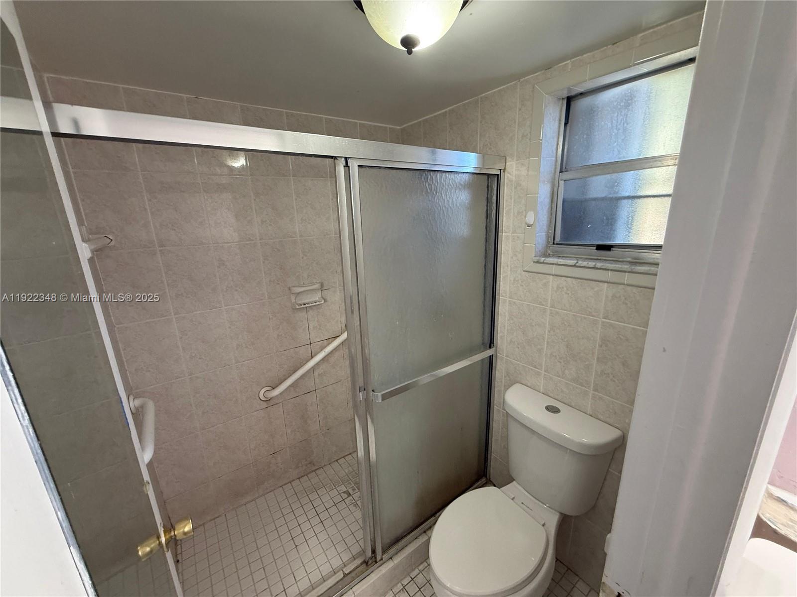 7355 West 4th Avenue, Unit 214 Hialeah, FL 33014 - Photo 13 of 15 a bathroom with a toilet and a shower