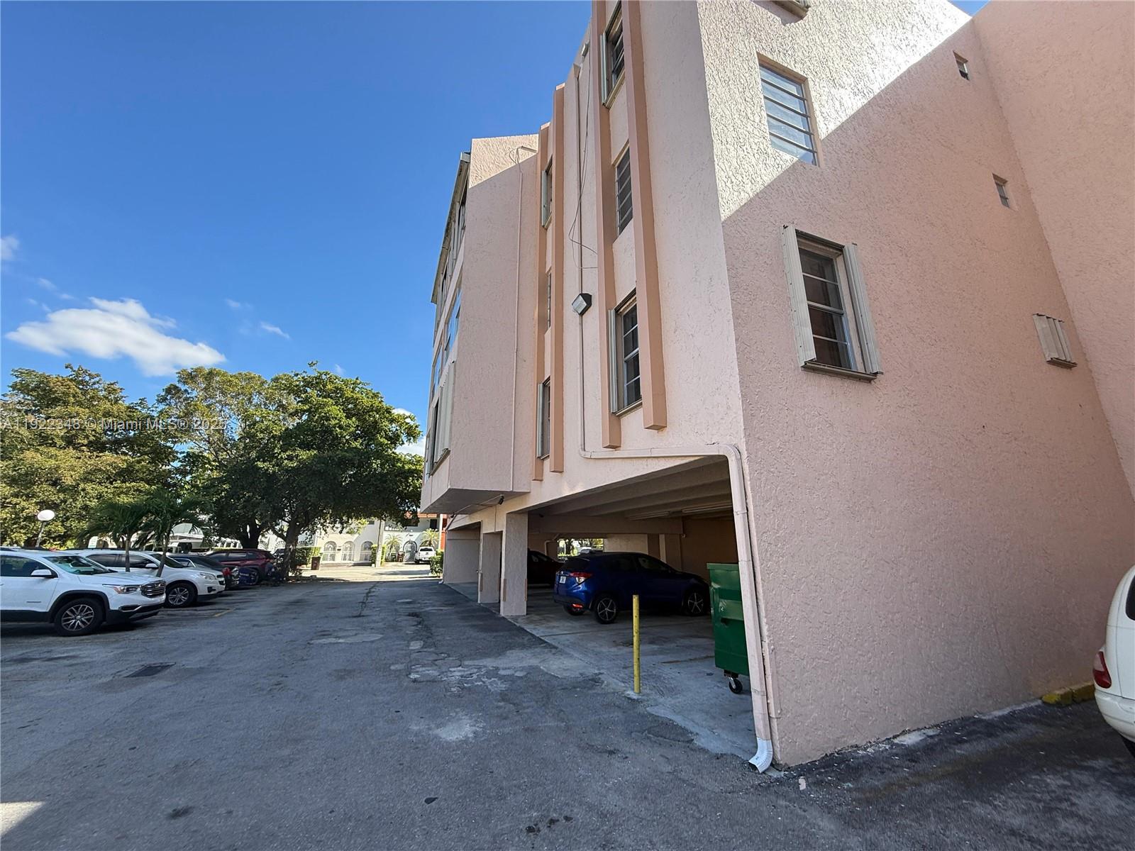 7355 West 4th Avenue, Unit 214 Hialeah, FL 33014 - Photo 14 of 15 a view of a car park in front of house