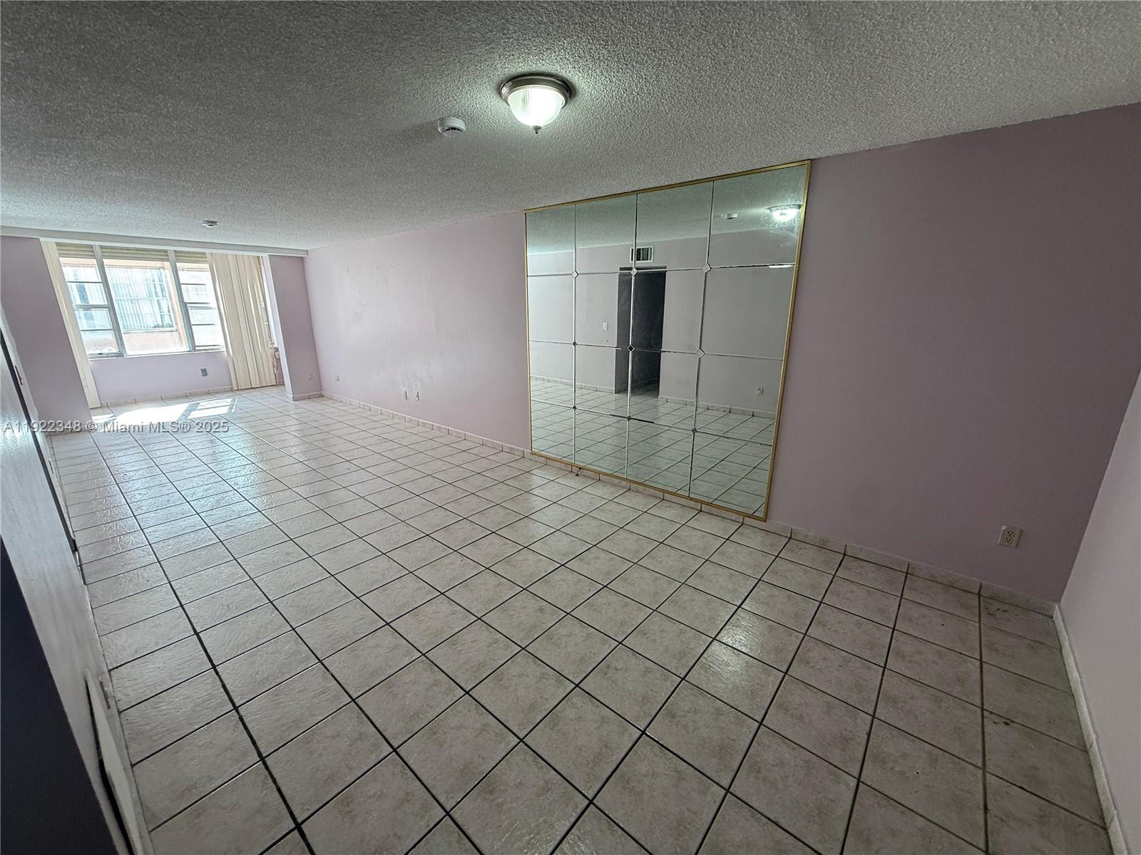 7355 West 4th Avenue, Unit 214 Hialeah, FL 33014 - Photo 4 of 15 a view of an empty room and window