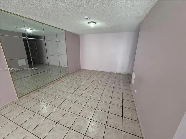 a view of an empty room and a bathroom