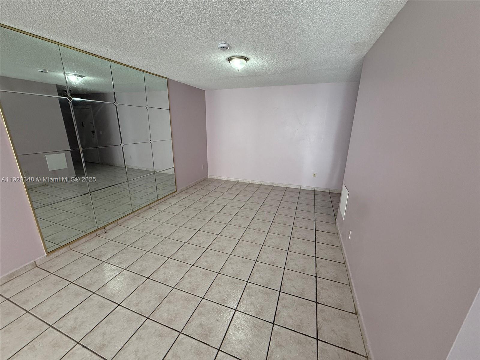 7355 West 4th Avenue, Unit 214 Hialeah, FL 33014 - Photo 6 of 15 a view of an empty room and a bathroom