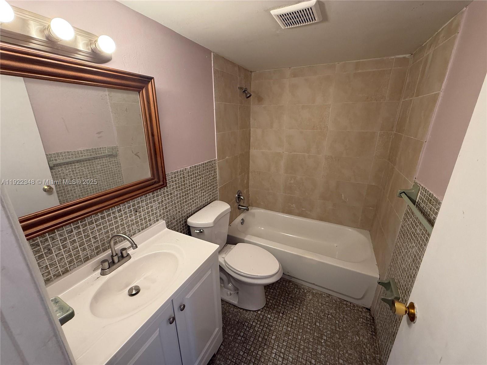 7355 West 4th Avenue, Unit 214 Hialeah, FL 33014 - Photo 7 of 15 a bathroom with a sink a toilet and shower