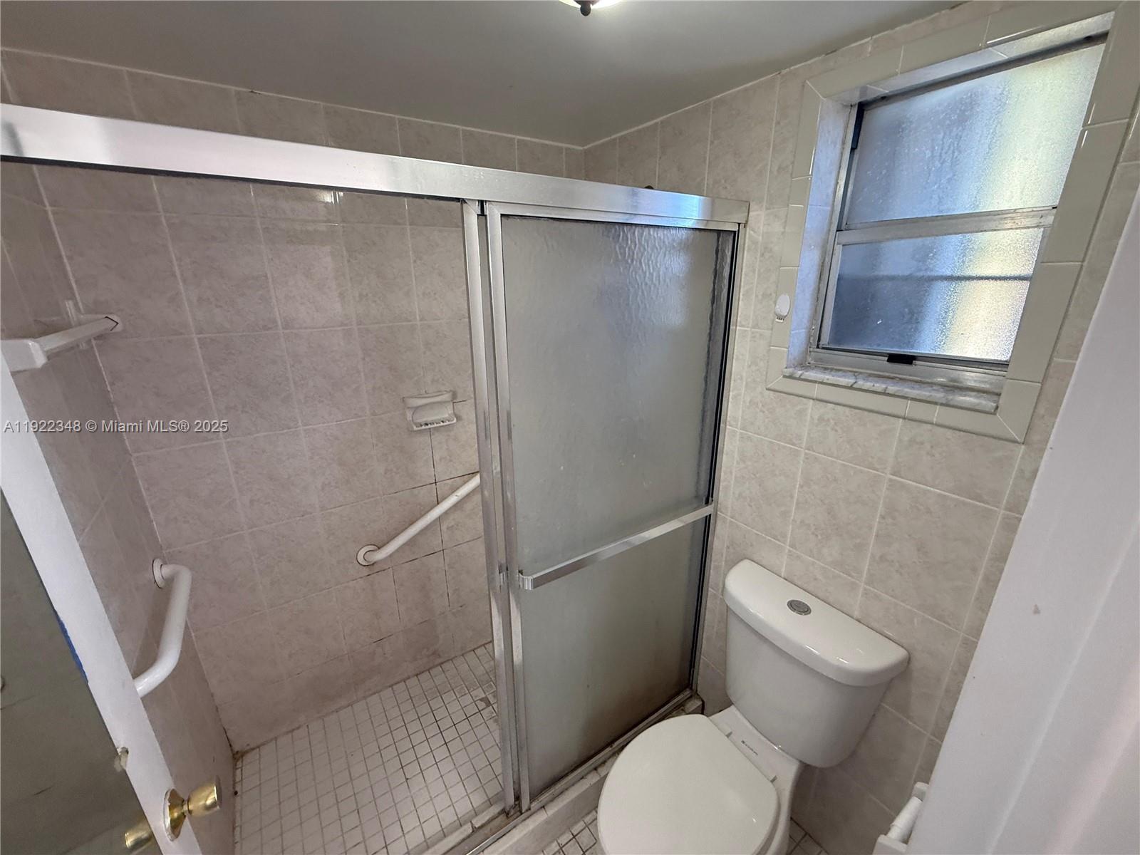7355 West 4th Avenue, Unit 214 Hialeah, FL 33014 - Photo 10 of 15 a bathroom with a toilet and a shower