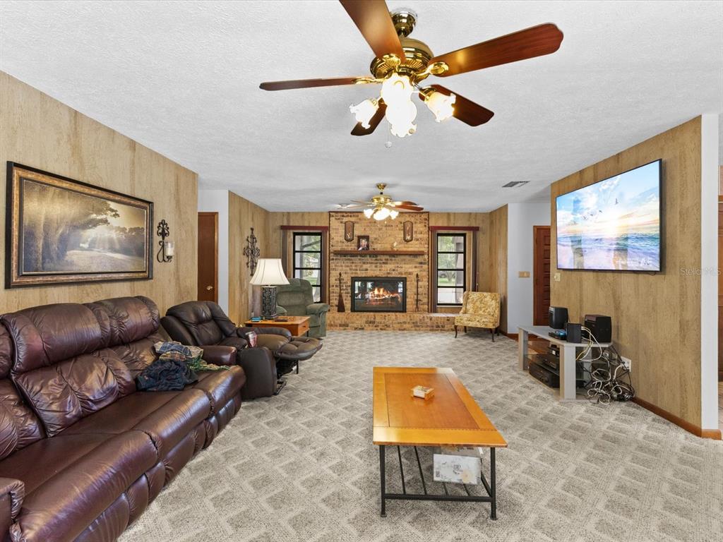 10700 Luscombe Court New Port Richey, FL 34654 - Photo 15 of 64 a living room with furniture and a flat screen tv
