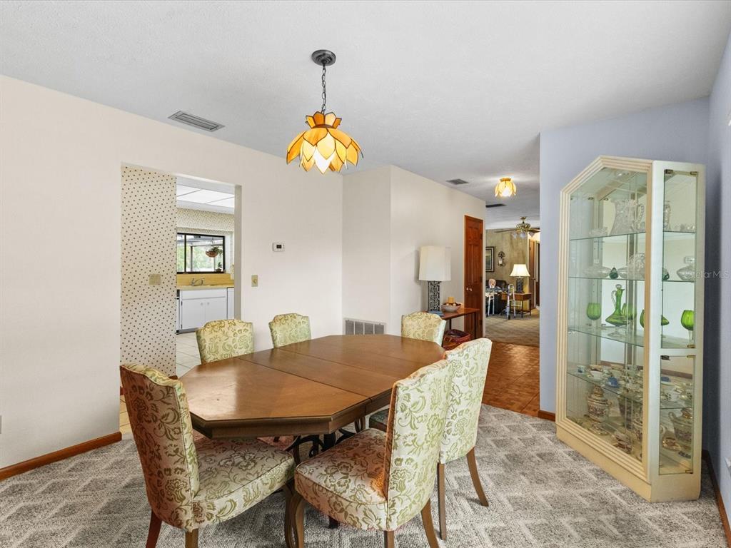 10700 Luscombe Court New Port Richey, FL 34654 - Photo 17 of 64 a view of a dining room with a table and chairs