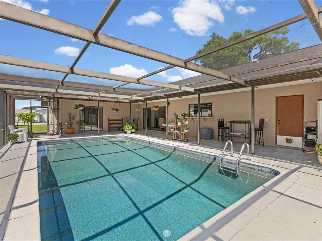 10700 Luscombe Court New Port Richey, FL 34654 - Photo 37 of 64 a outdoor living space with patio furniture and a potted plant