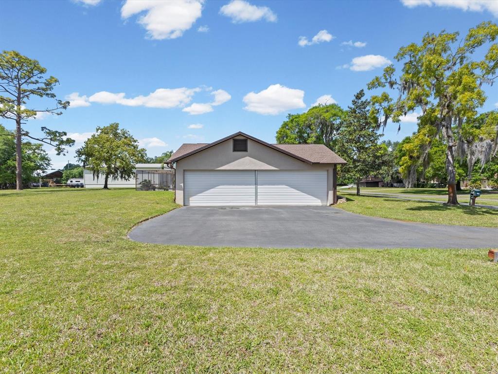 10700 Luscombe Court New Port Richey, FL 34654 - Photo 39 of 64 a house view with a garden space