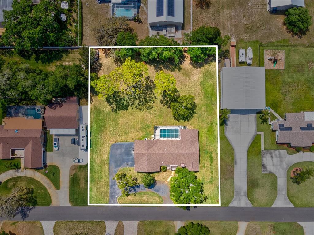 10700 Luscombe Court New Port Richey, FL 34654 - Photo 48 of 64 an aerial view of residential houses with outdoor space and swimming pool