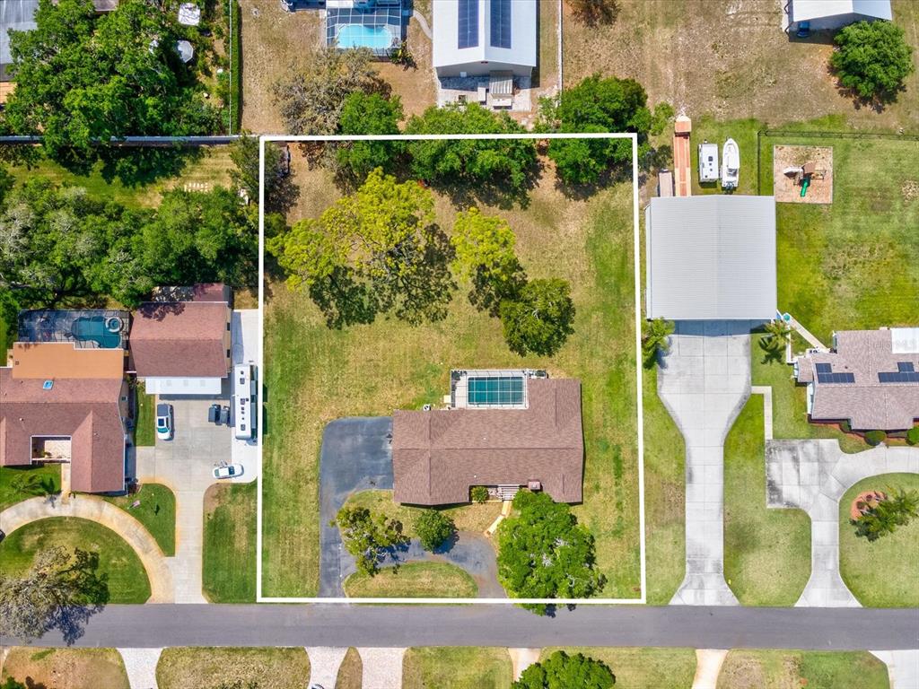 10700 Luscombe Court New Port Richey, FL 34654 - Photo 49 of 64 an aerial view of residential houses with outdoor space
