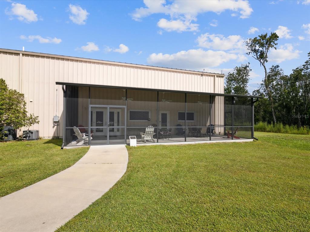 10700 Luscombe Court New Port Richey, FL 34654 - Photo 50 of 64 a view of a house with swimming pool and a yard