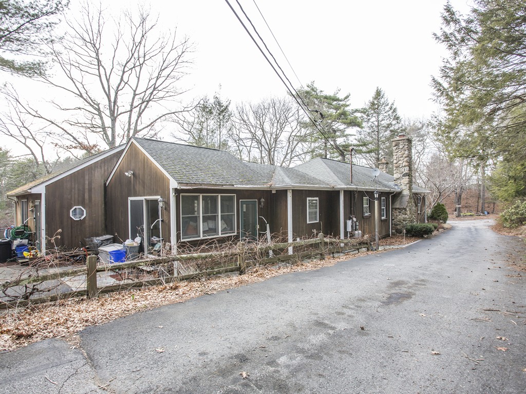 a front view of house with yard outdoor seating and barbeque oven