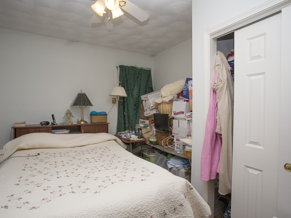 71 Tifft Road North Smithfield, RI 02896 - Photo 22 of 30 a bedroom with a bed and a chandelier
