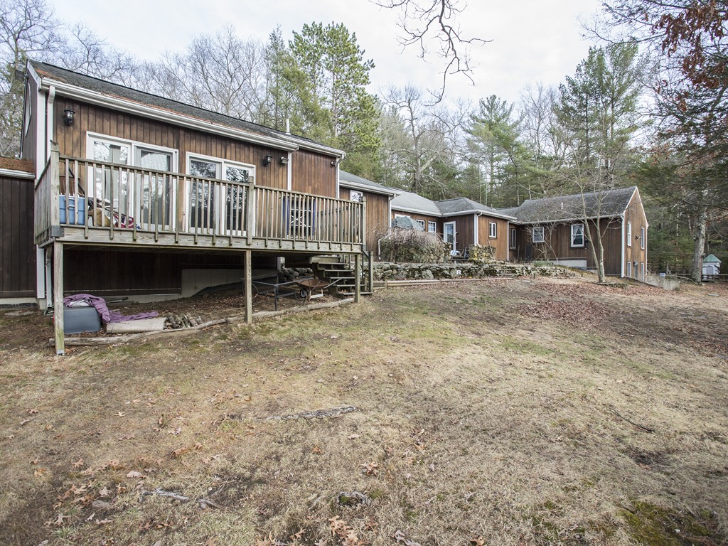 71 Tifft Road North Smithfield, RI 02896 - Photo 5 of 30 a backyard of a house with wooden deck and barbeque oven