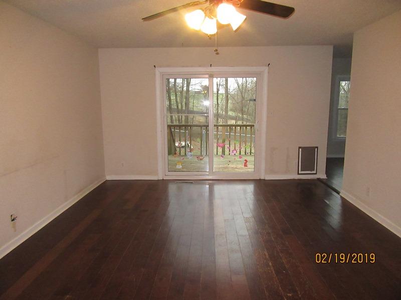 3563 Marthas Chapel Road Cunningham, TN 37052 - Photo 2 of 9 an empty room with wooden floor and windows