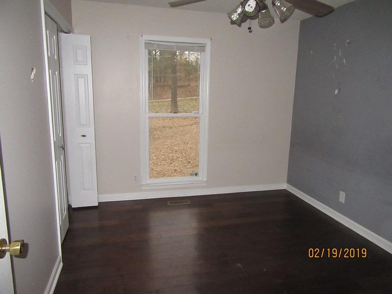 3563 Marthas Chapel Road Cunningham, TN 37052 - Photo 4 of 9 an empty room with wooden floor and windows