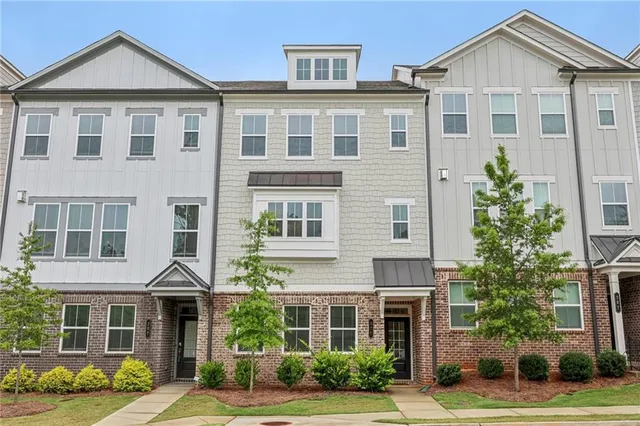 a front view of a house with a yard