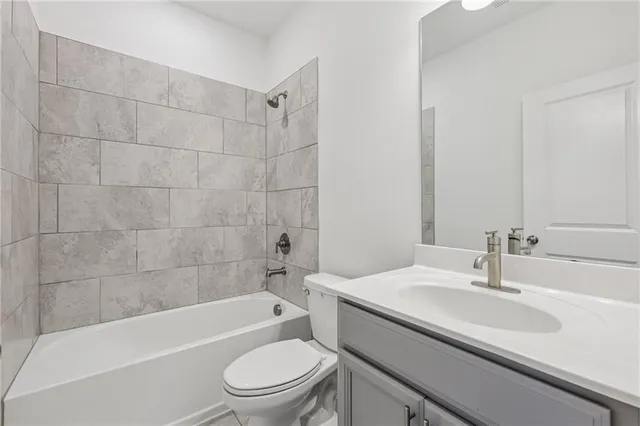 a bathroom with a sink a toilet and bathtub