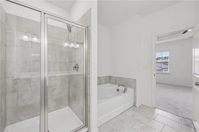 a white bath tub sitting next to a shower
