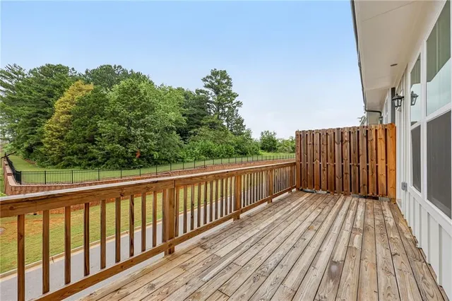 a balcony with wooden floor and fence
