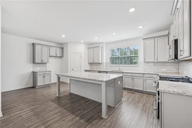 a kitchen with a sink stove and cabinets