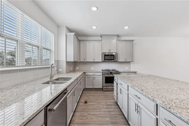 a kitchen with granite countertop kitchen island sink stove and granite counter tops