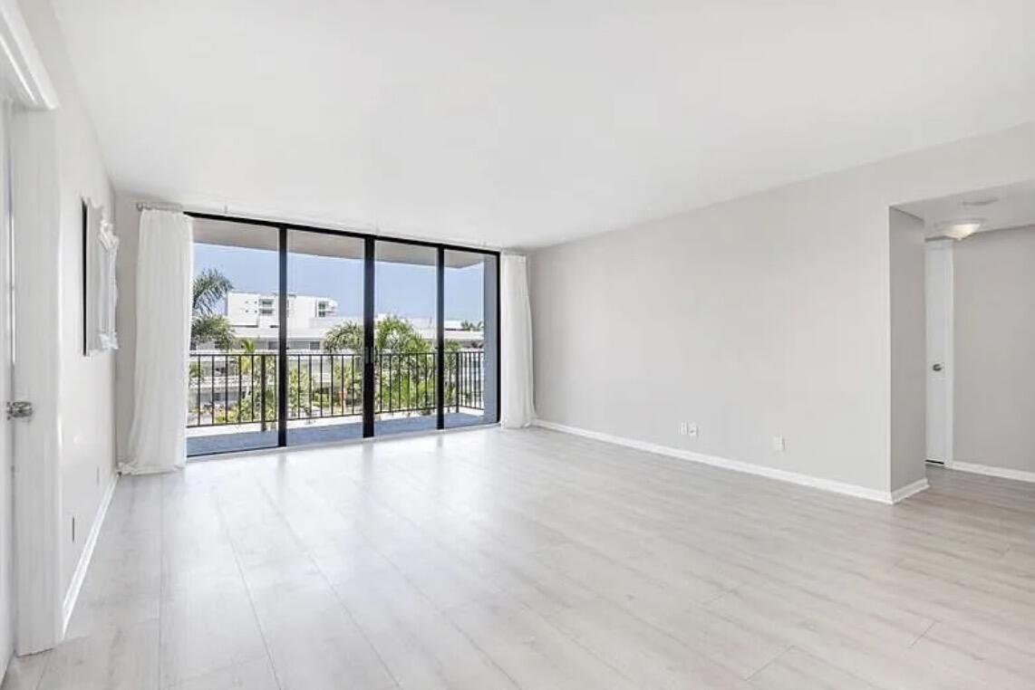 3800 Washington Road, Unit 310 West Palm Beach, FL 33405 - Photo 7 of 15 wooden floor in an empty room with a window