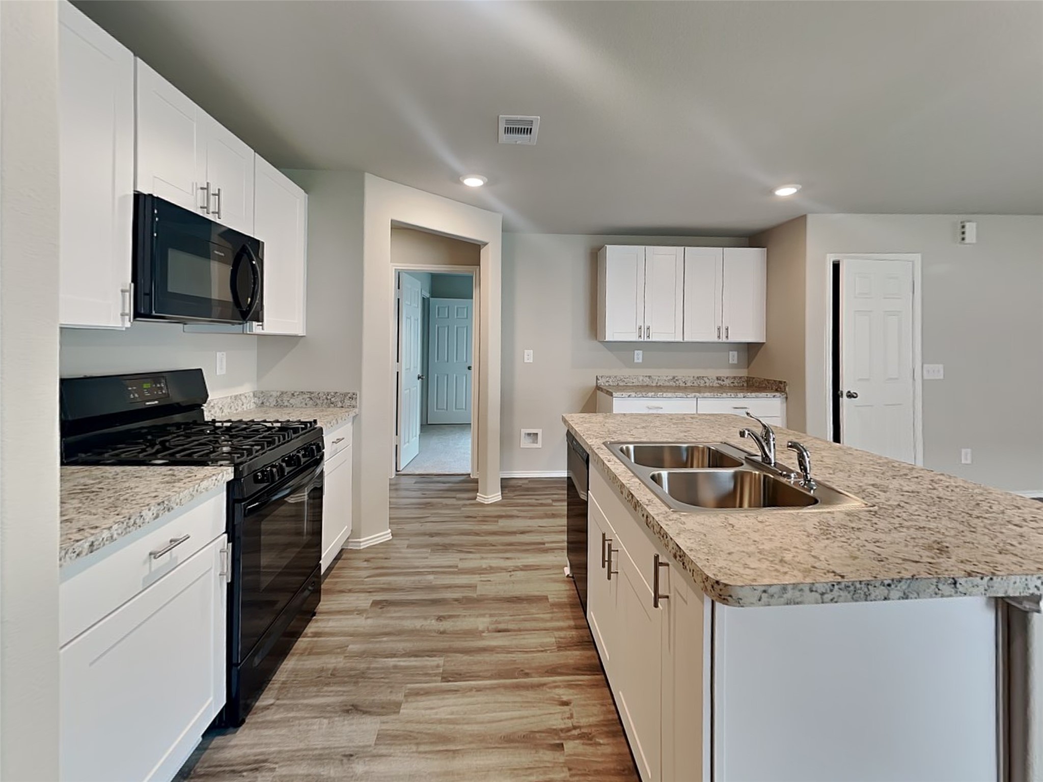 1907 Evening Breeze Lane Houston, TX 77073 - Photo 2 of 16 a kitchen with stainless steel appliances granite countertop a stove a sink and a microwave