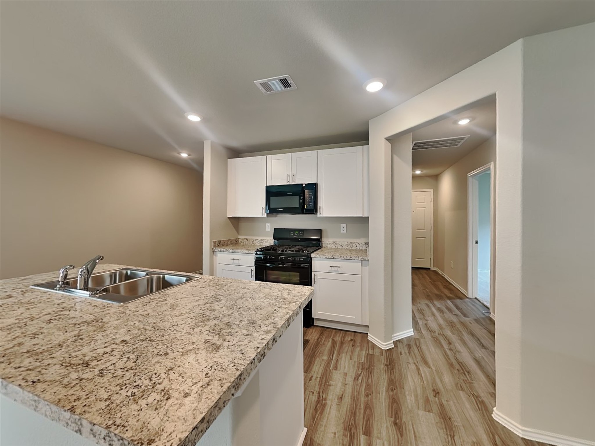 1907 Evening Breeze Lane Houston, TX 77073 - Photo 3 of 16 a kitchen with granite countertop a sink and a stove top oven