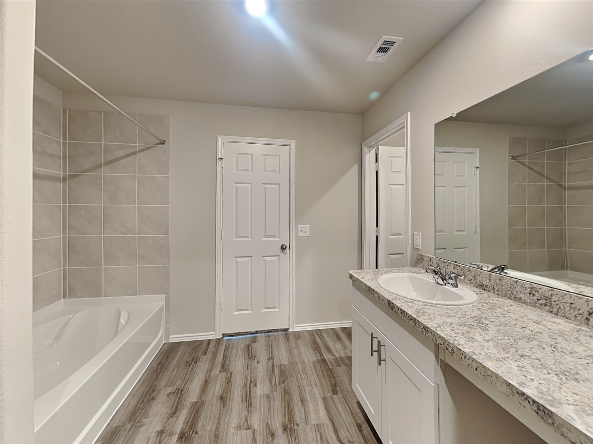 1907 Evening Breeze Lane Houston, TX 77073 - Photo 9 of 16 a bathroom with a granite countertop sink a mirror and a bathtub